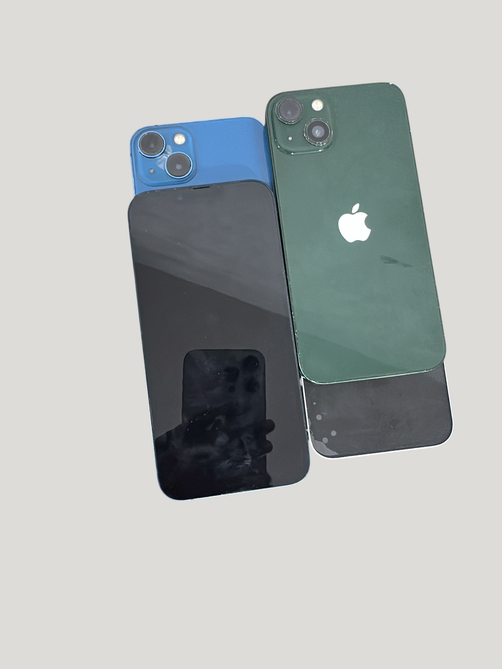 Iphoneio Official Apple iPhone 13 smartphones in blue and green with dual-camera systems and glass backs.