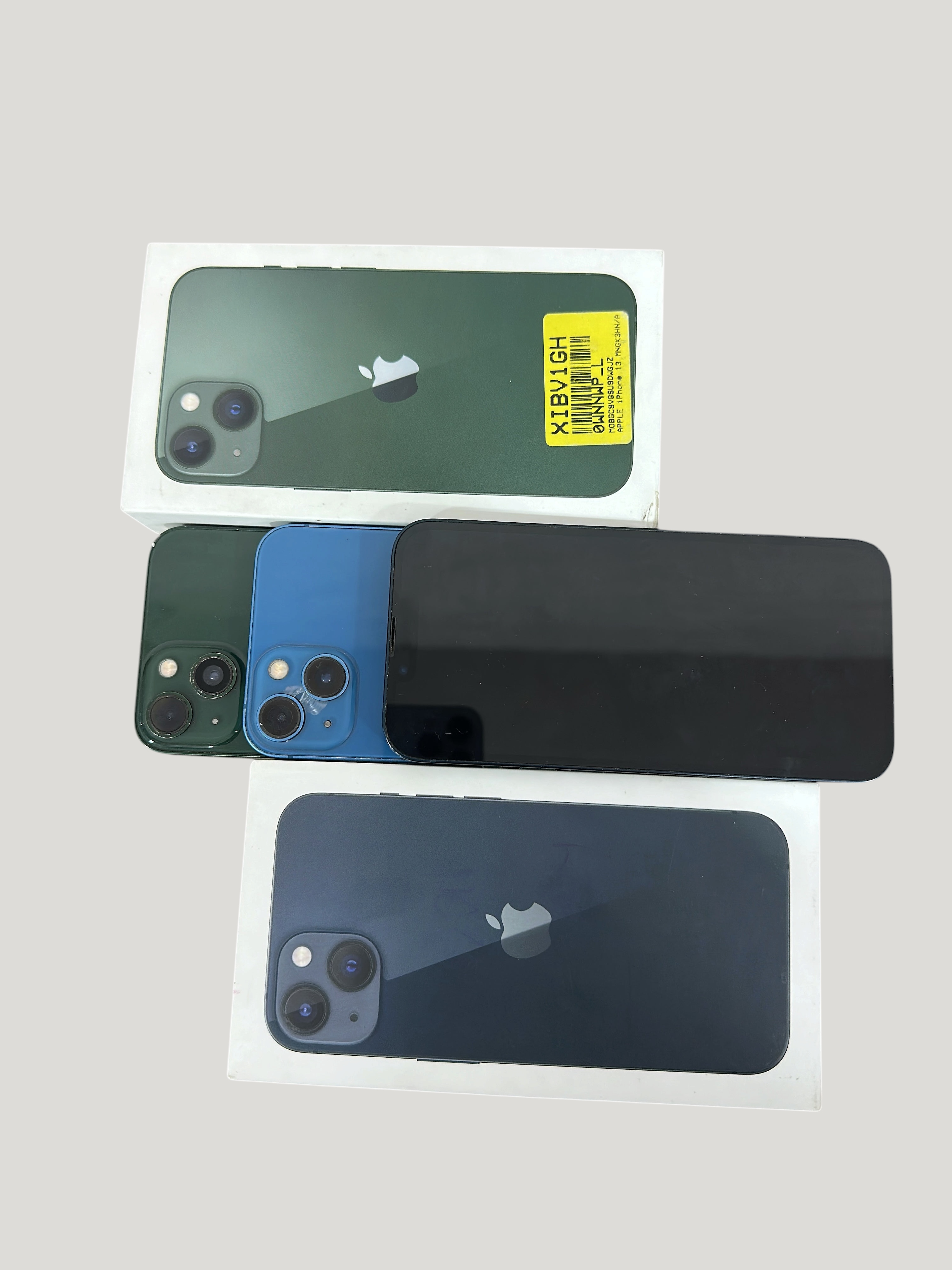 Iphoneio Official Apple iPhone 13 collection in green and blue with original packaging boxes on black background