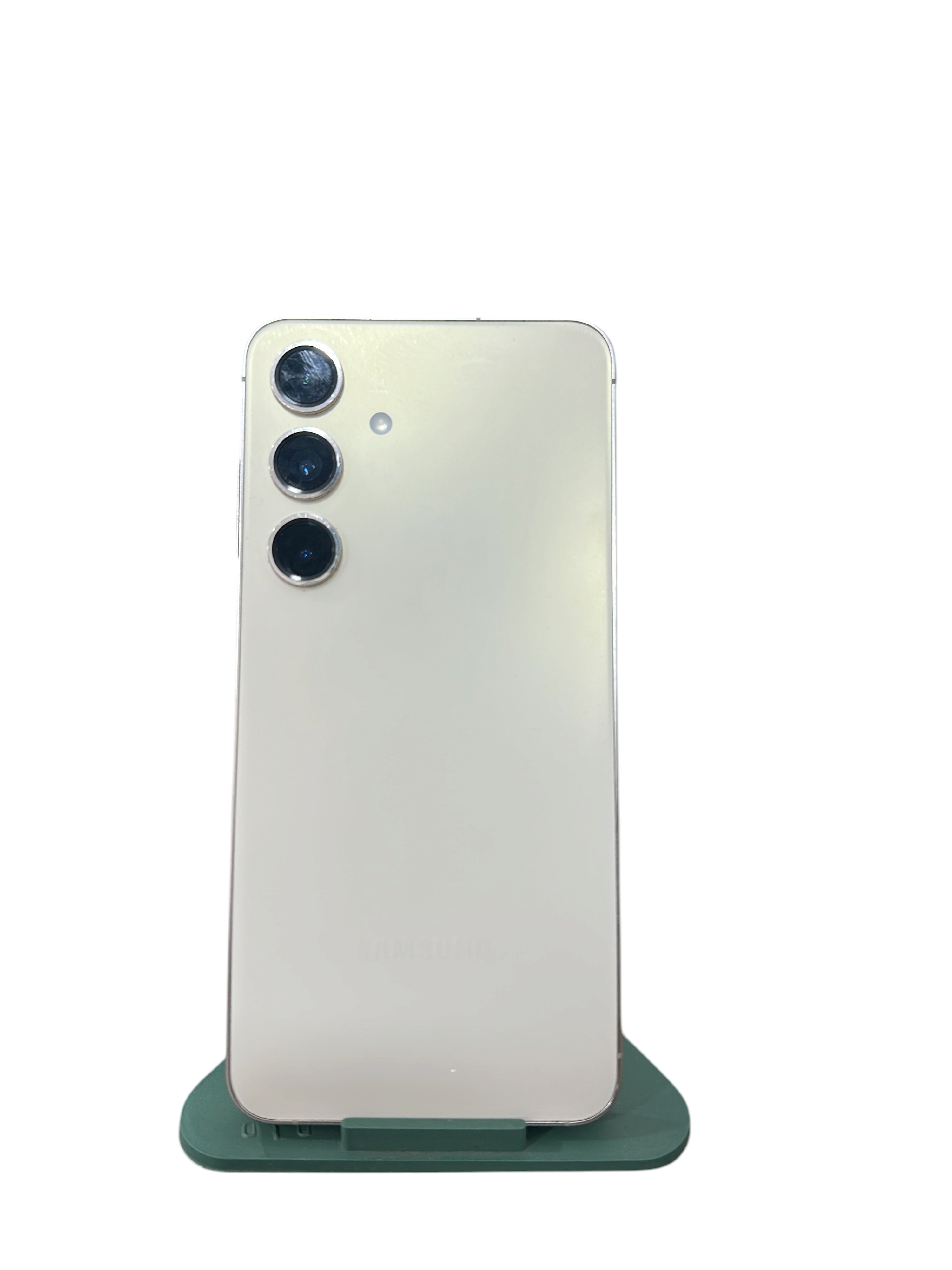 Iphoneio Official cream Samsung Galaxy smartphone with a triple-lens camera system on a green stand against black