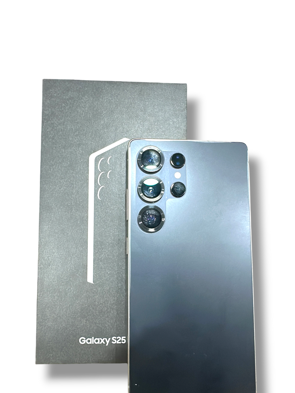 Iphoneio Official Galaxy S25 smartphone in grey with a multi-lens camera system, displayed next to its product box.
