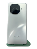 Iphoneio Official iQOO smartphone in pearlescent white with a prominent rear camera module and OIS technology