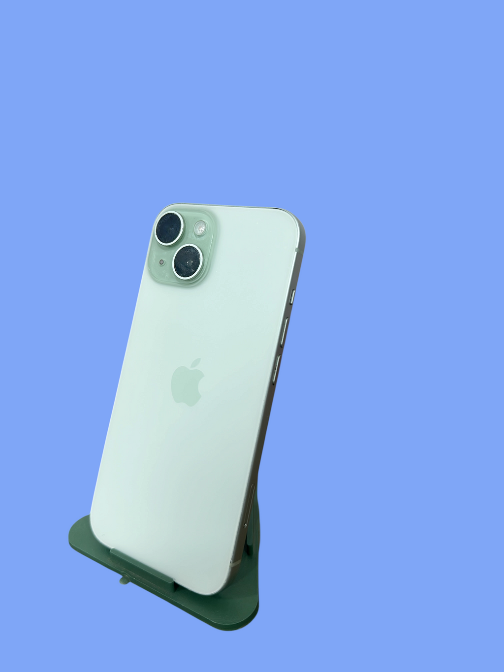 Iphoneio Official light green Apple iPhone smartphone with dual camera system on a stand against a black background