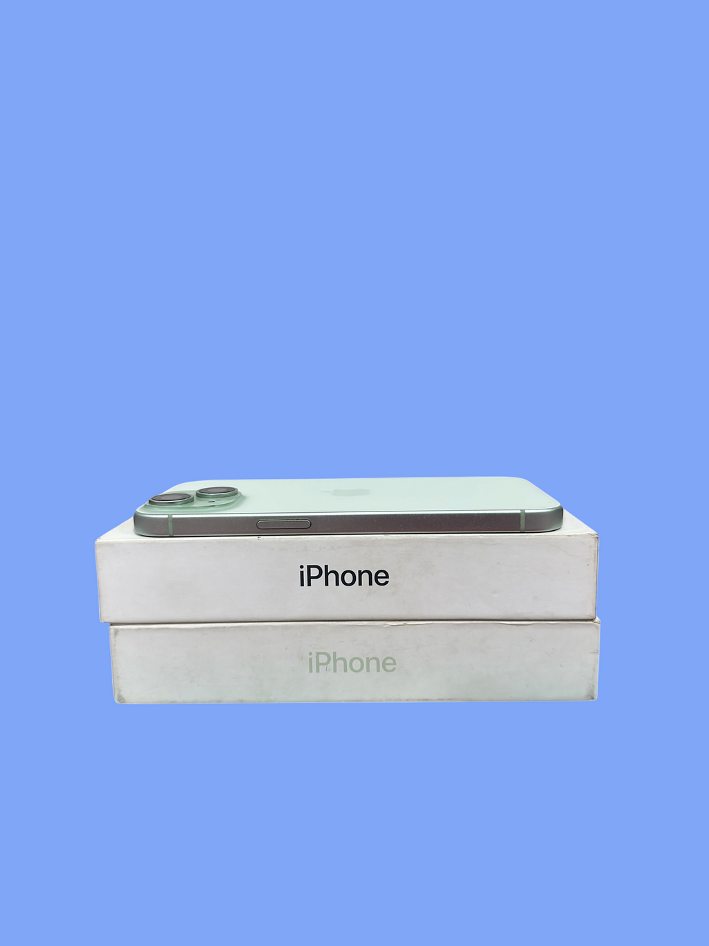 Iphoneio Official light green iPhone smartphone resting on top of its white product packaging boxes