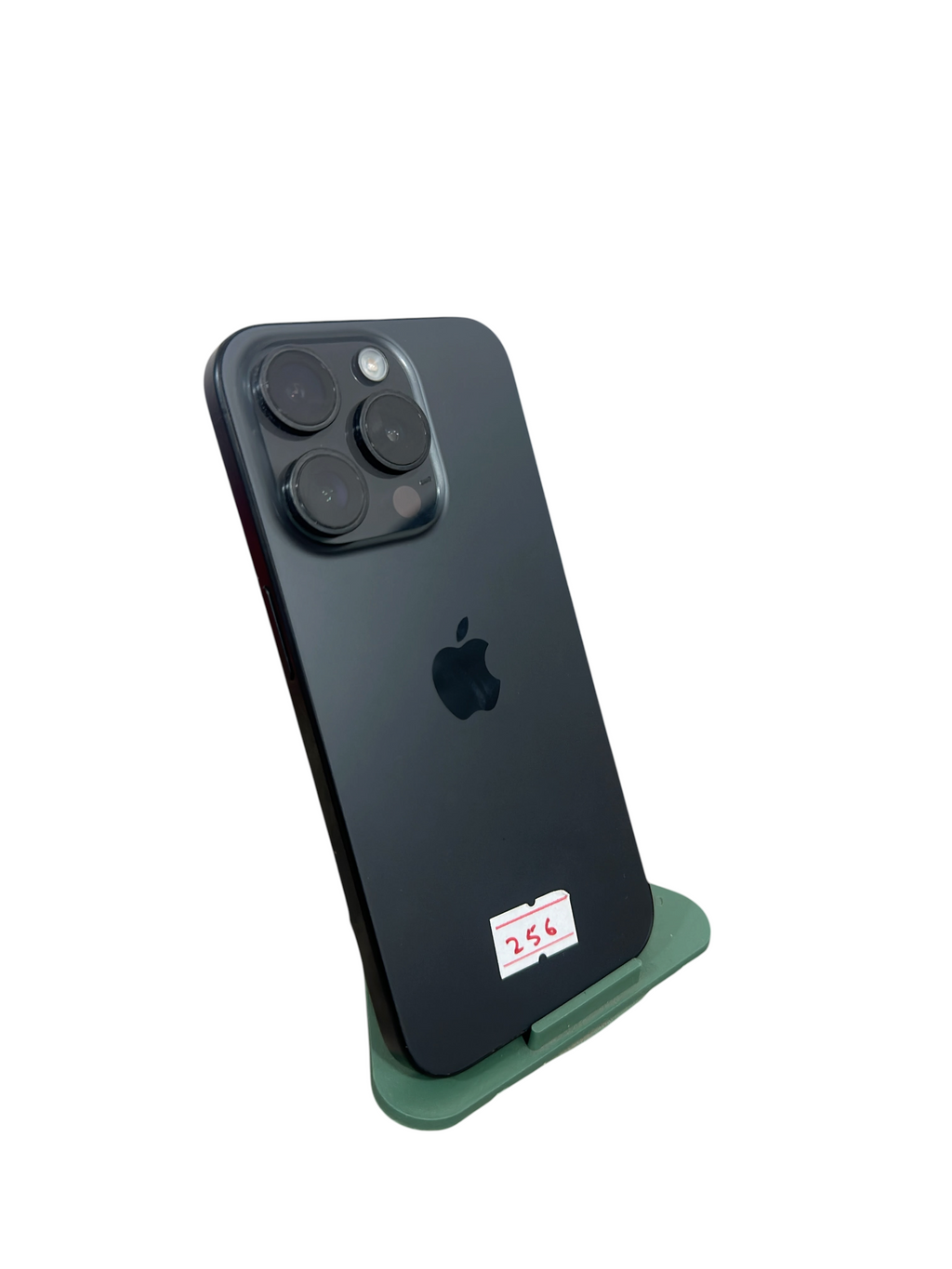 Iphoneio Official premium smartphone in matte black with a triple-lens camera system on a green display stand