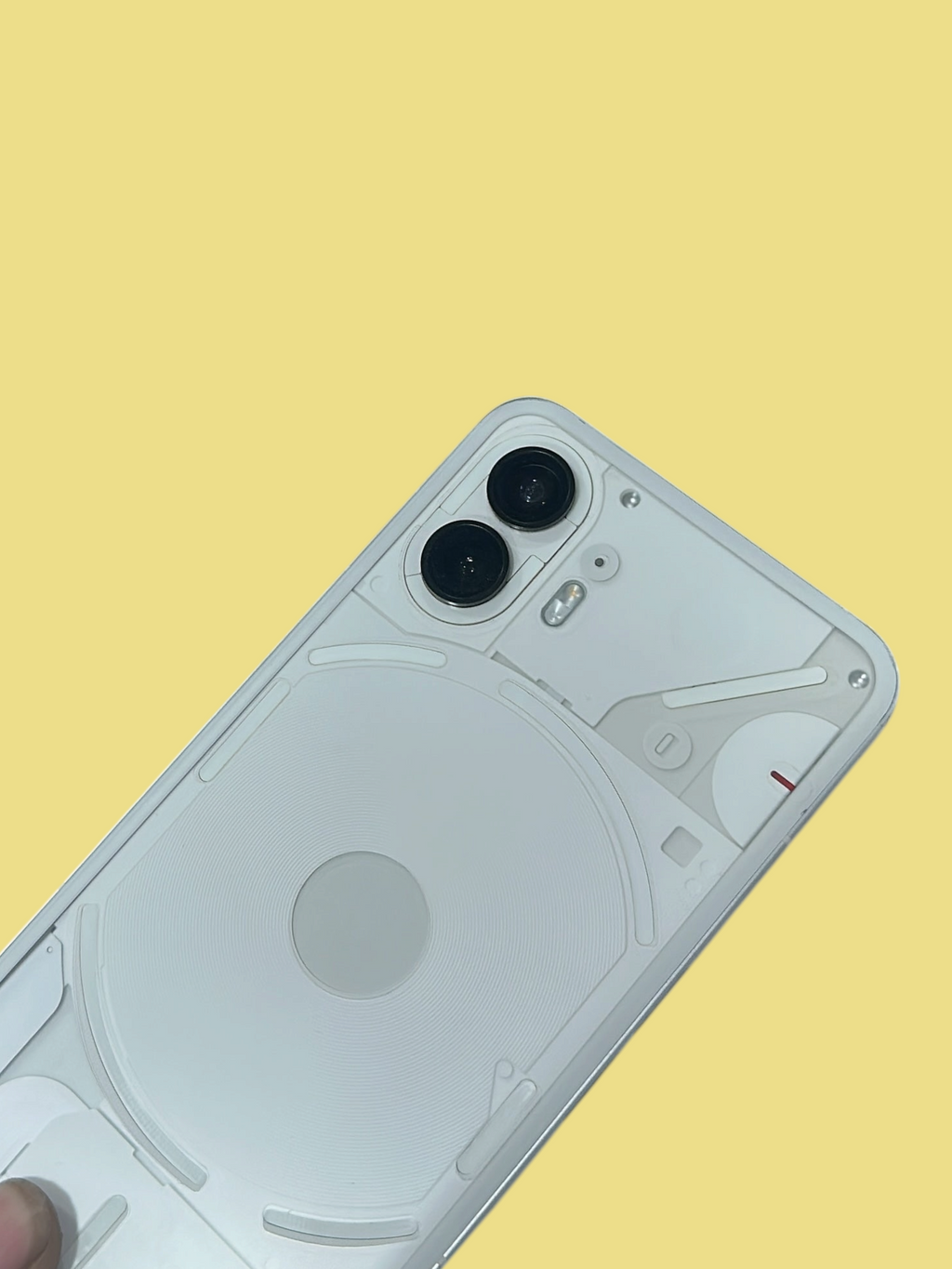 Iphoneio Official Nothing Phone 2 in white with a transparent back and dual camera system held in a hand