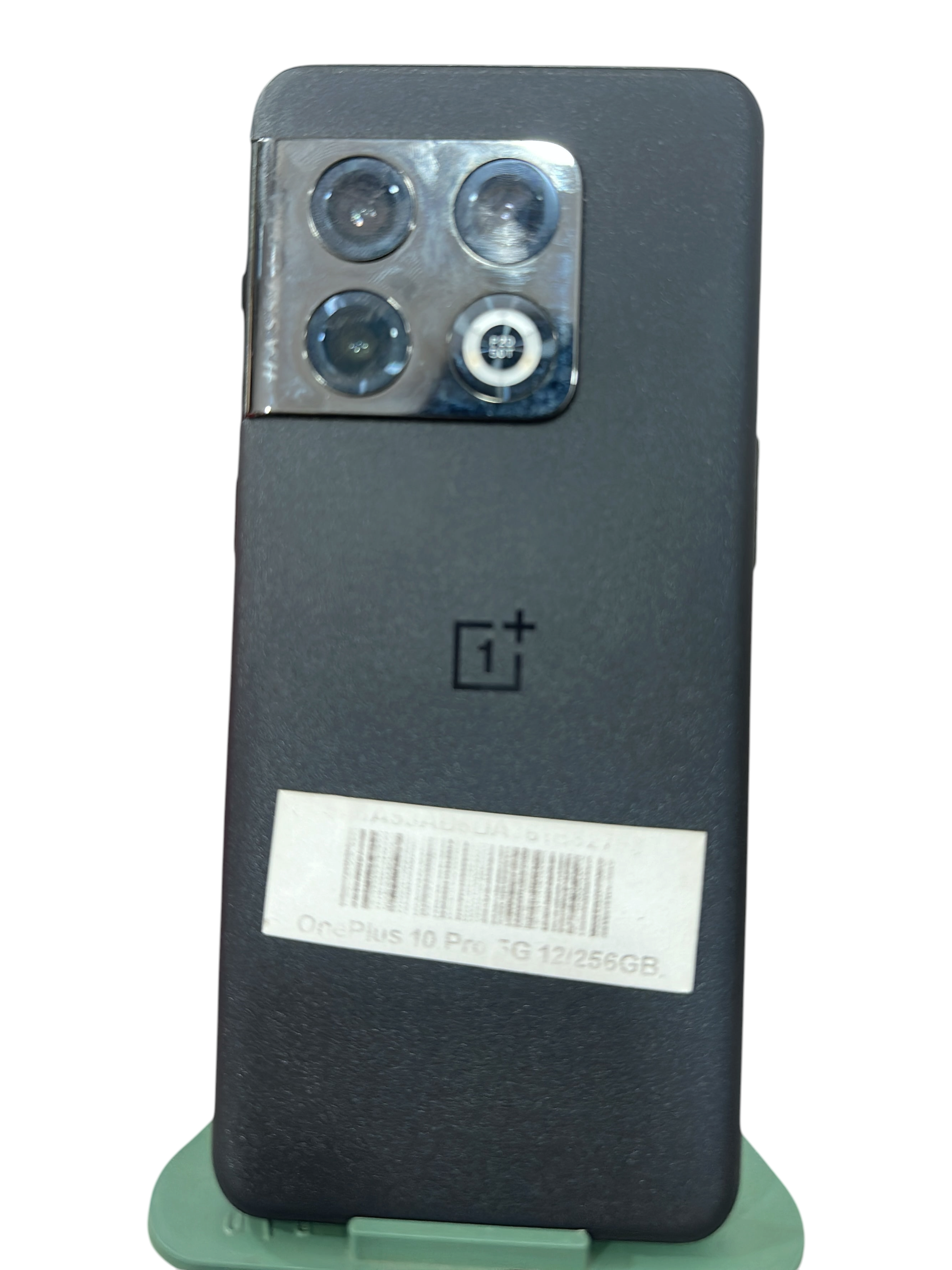 Iphoneio Official OnePlus 10 Pro 5G smartphone in matte black with a triple camera system on a green stand