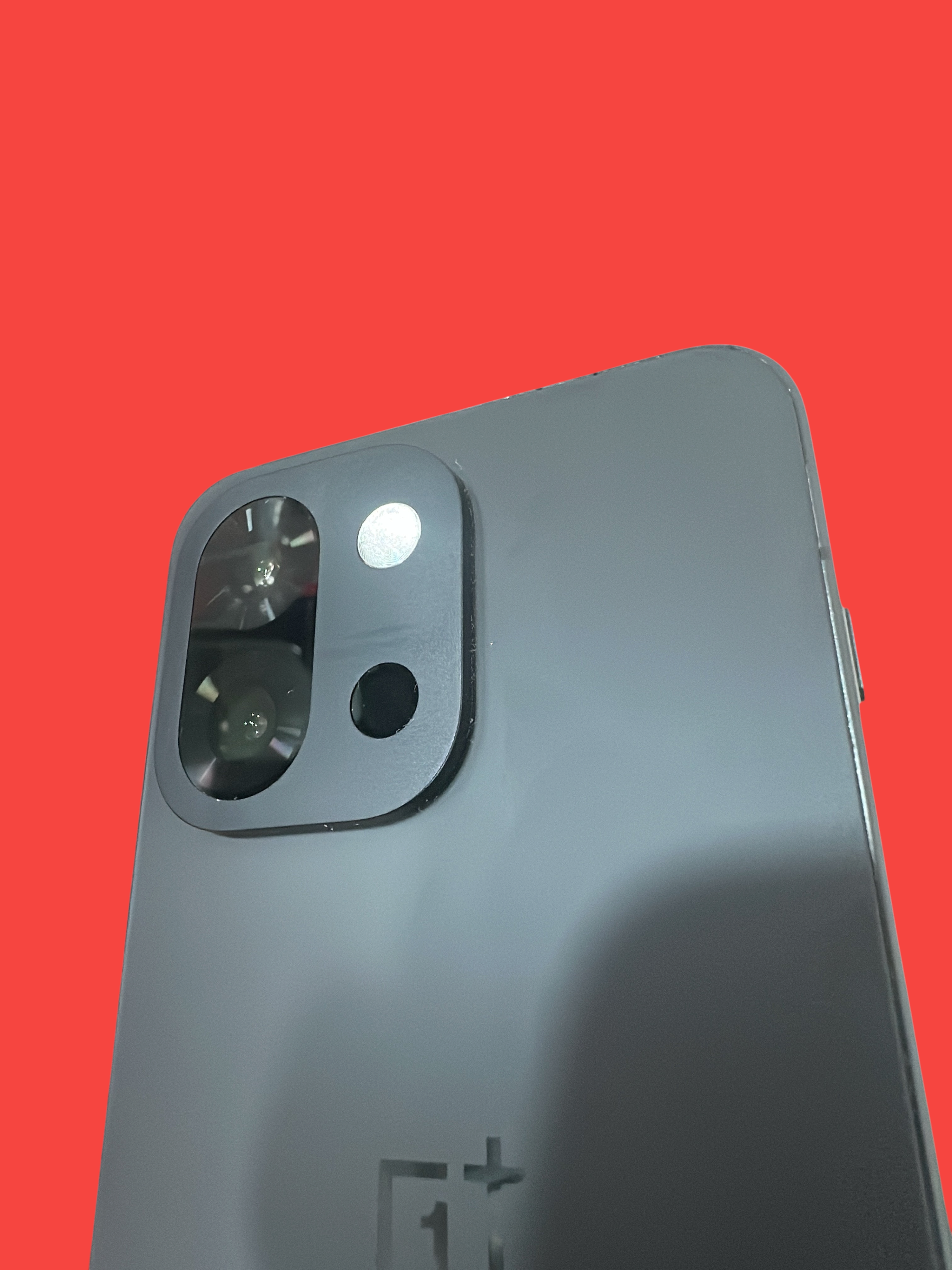 Iphoneio Official OnePlus Nord CE4 smartphone in matte charcoal with a dual-lens camera module on a black background.