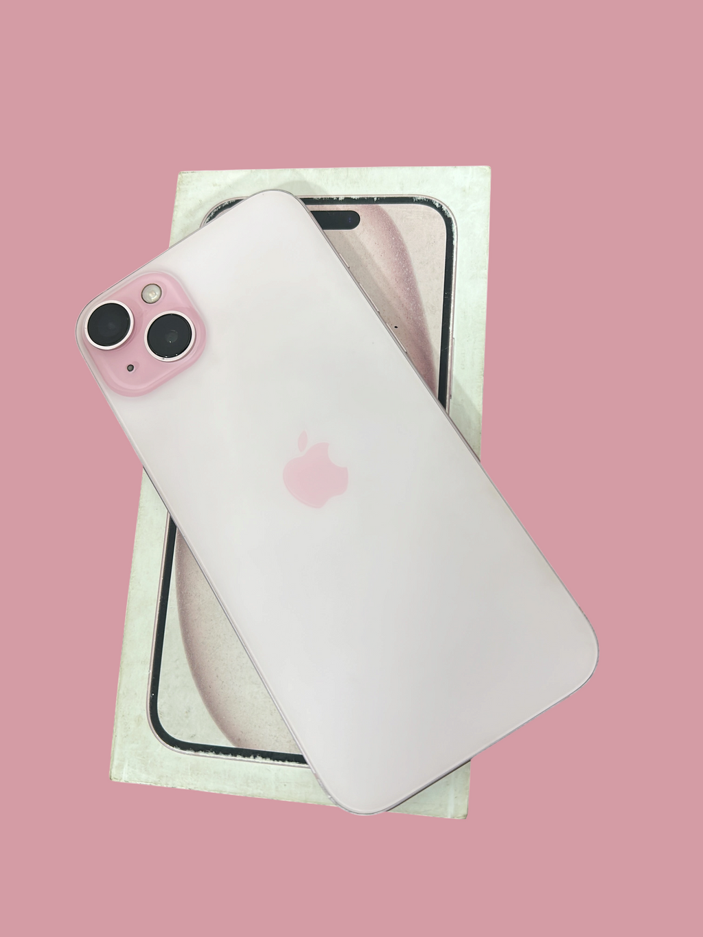 Iphoneio Official Apple iPhone 15 Plus in light pink with dual-camera system resting on its original product box