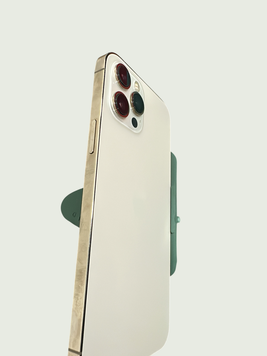 Iphoneio Official premium smartphone in light finish with metallic accents and triple-lens camera system, side view.