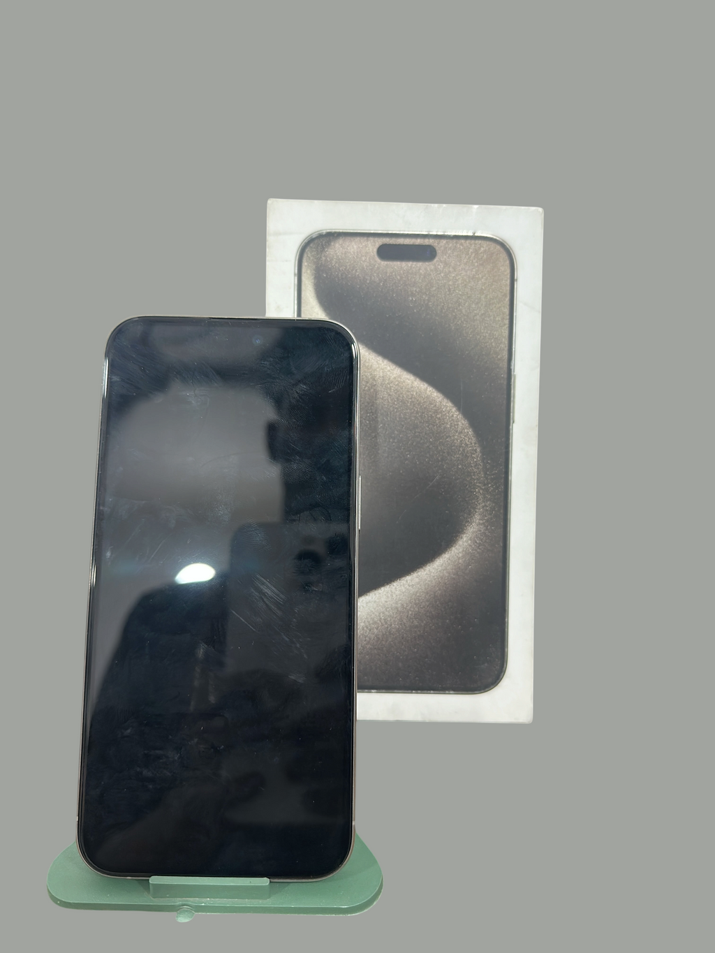 Iphoneio Official premium smartphone with titanium frame and original retail box on a green display stand