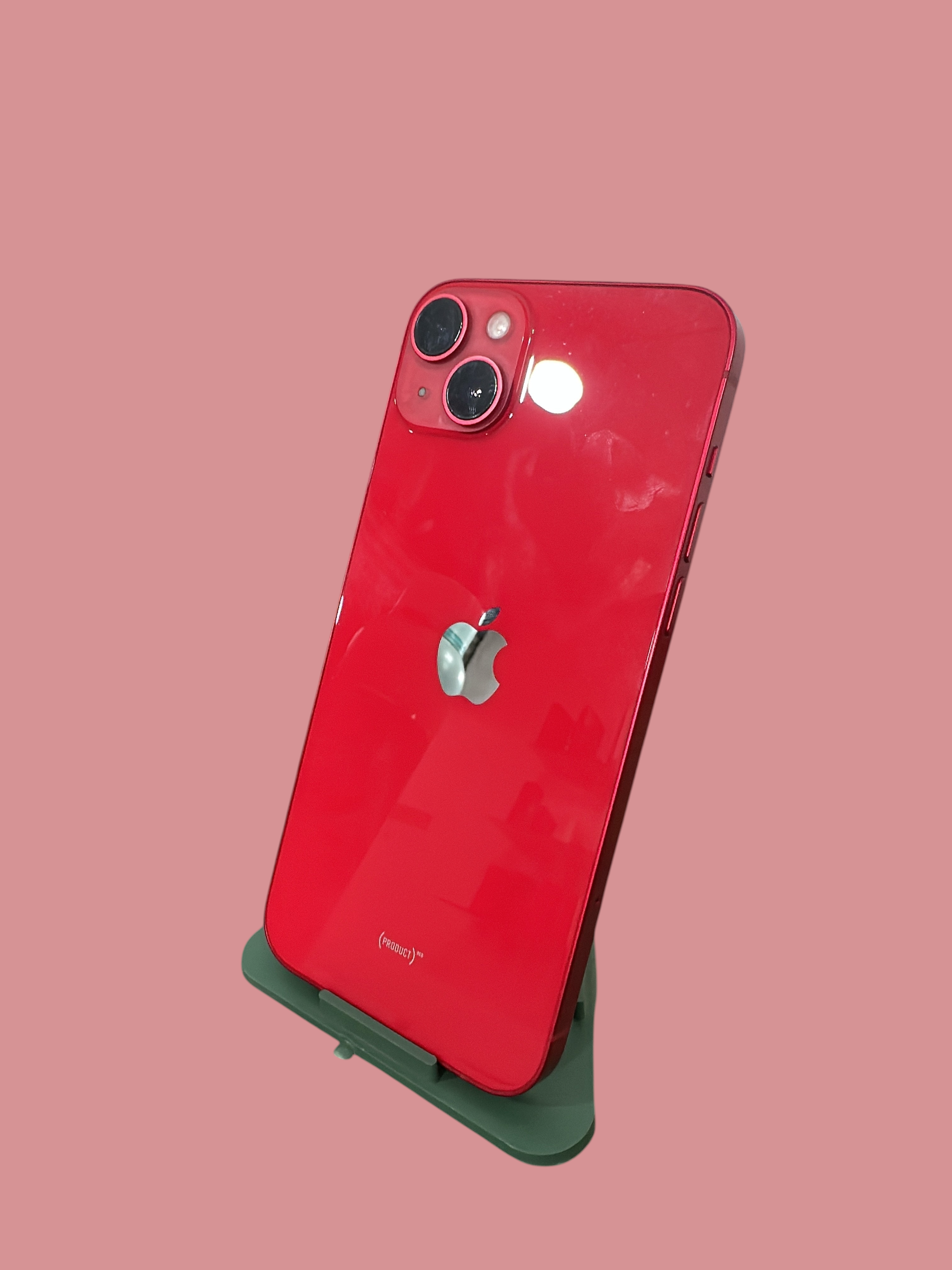 Iphoneio Official red smartphone with dual-camera system and glass back on a display stand