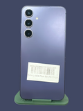 Iphoneio Official Samsung Galaxy S24 Plus 5G smartphone in purple with a triple camera system on a green stand.