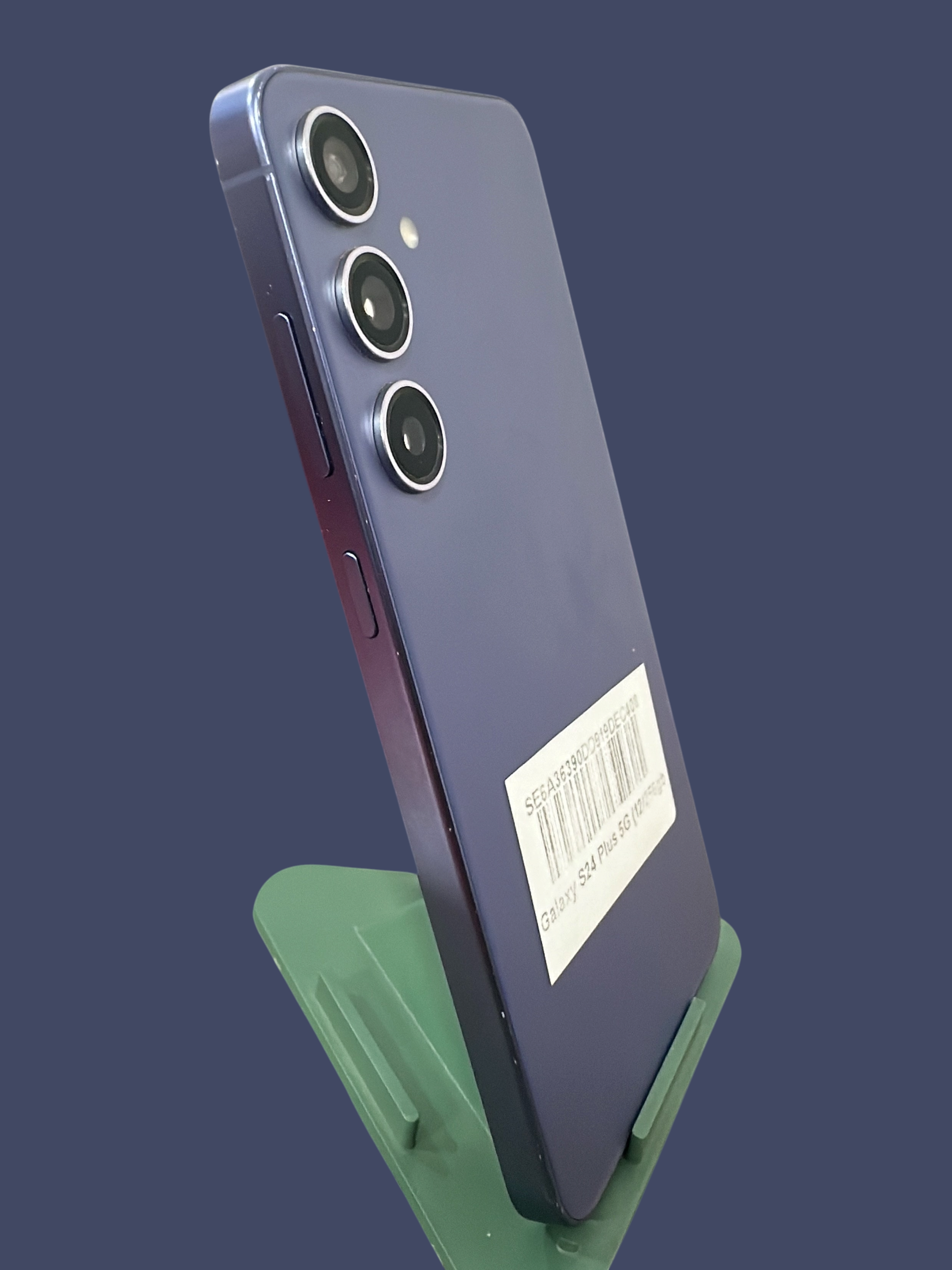 Iphoneio Official Samsung Galaxy S24 Plus 5G smartphone in purple with a triple camera system on a green stand