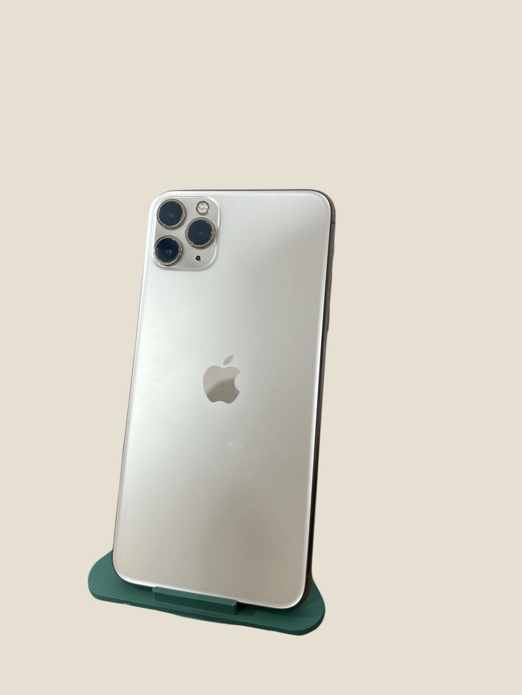 Iphoneio Official iPhone 11 Pro in silver with a triple-camera system and glass back on a green stand