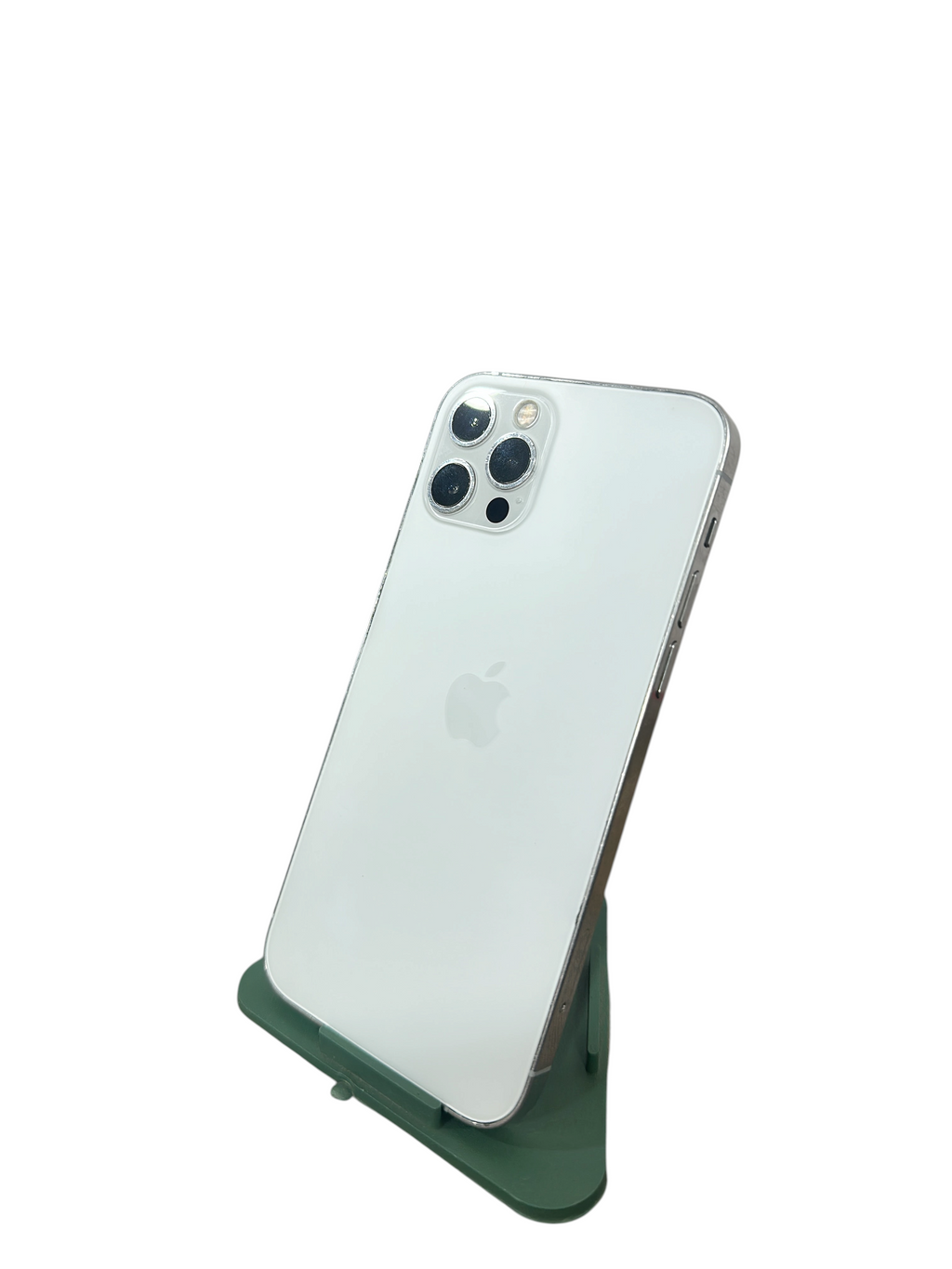 Iphoneio Official pre-owned iPhone 12 Pro in silver with a triple-camera system and matte glass back on a green stand.