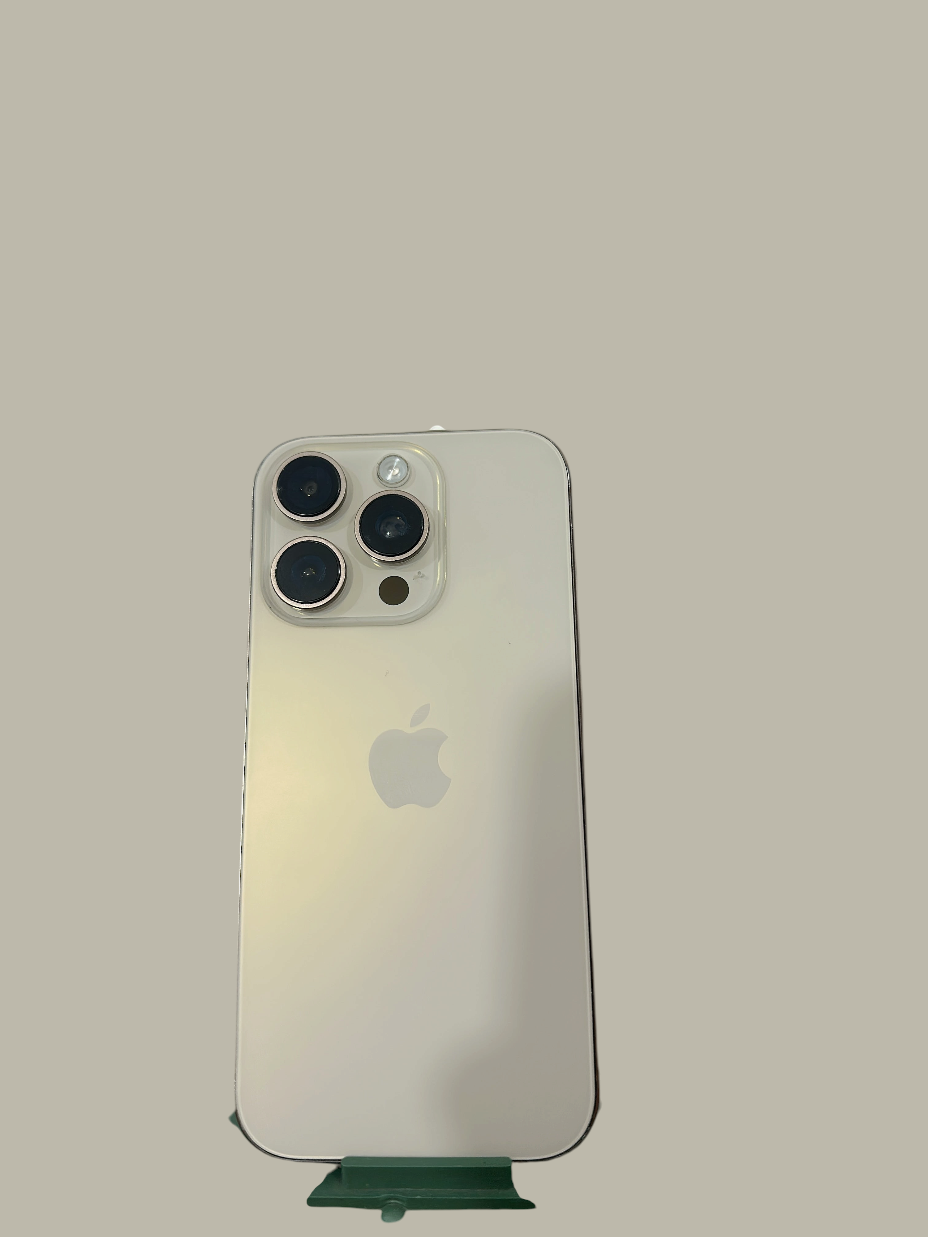 Iphoneio Official premium smartphone in silver with a triple-lens camera system on a black background