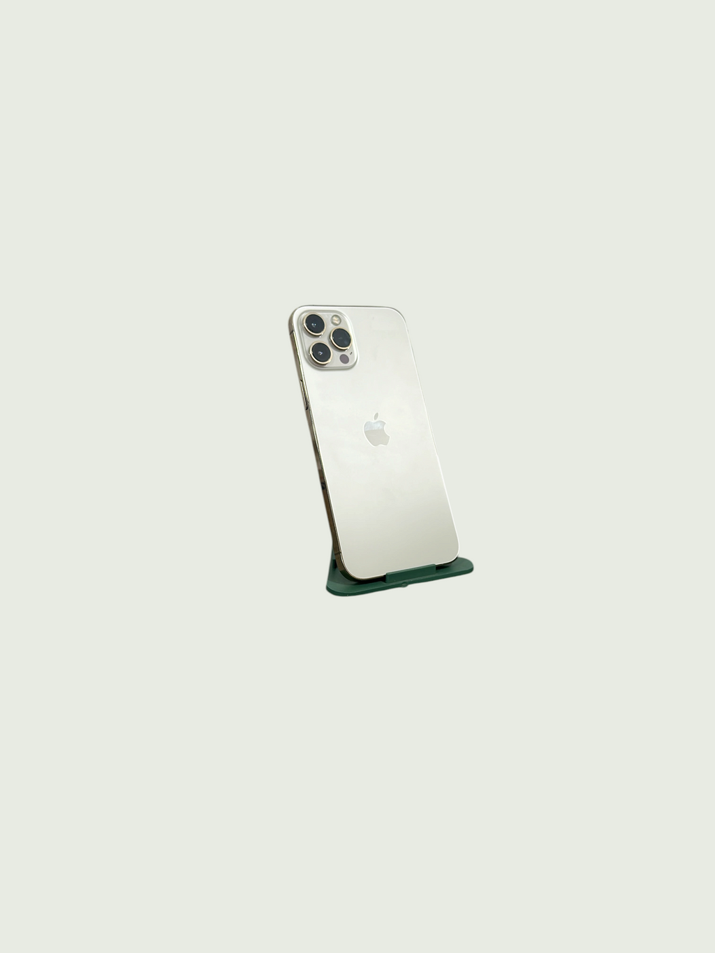 Iphoneio Official premium smartphone in silver with a triple-lens camera system on a green stand against black