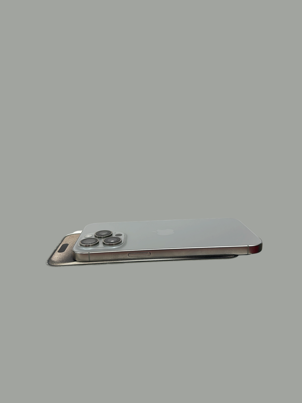 Iphoneio Official premium smartphone with titanium frame and triple-camera system resting on its original white box.
