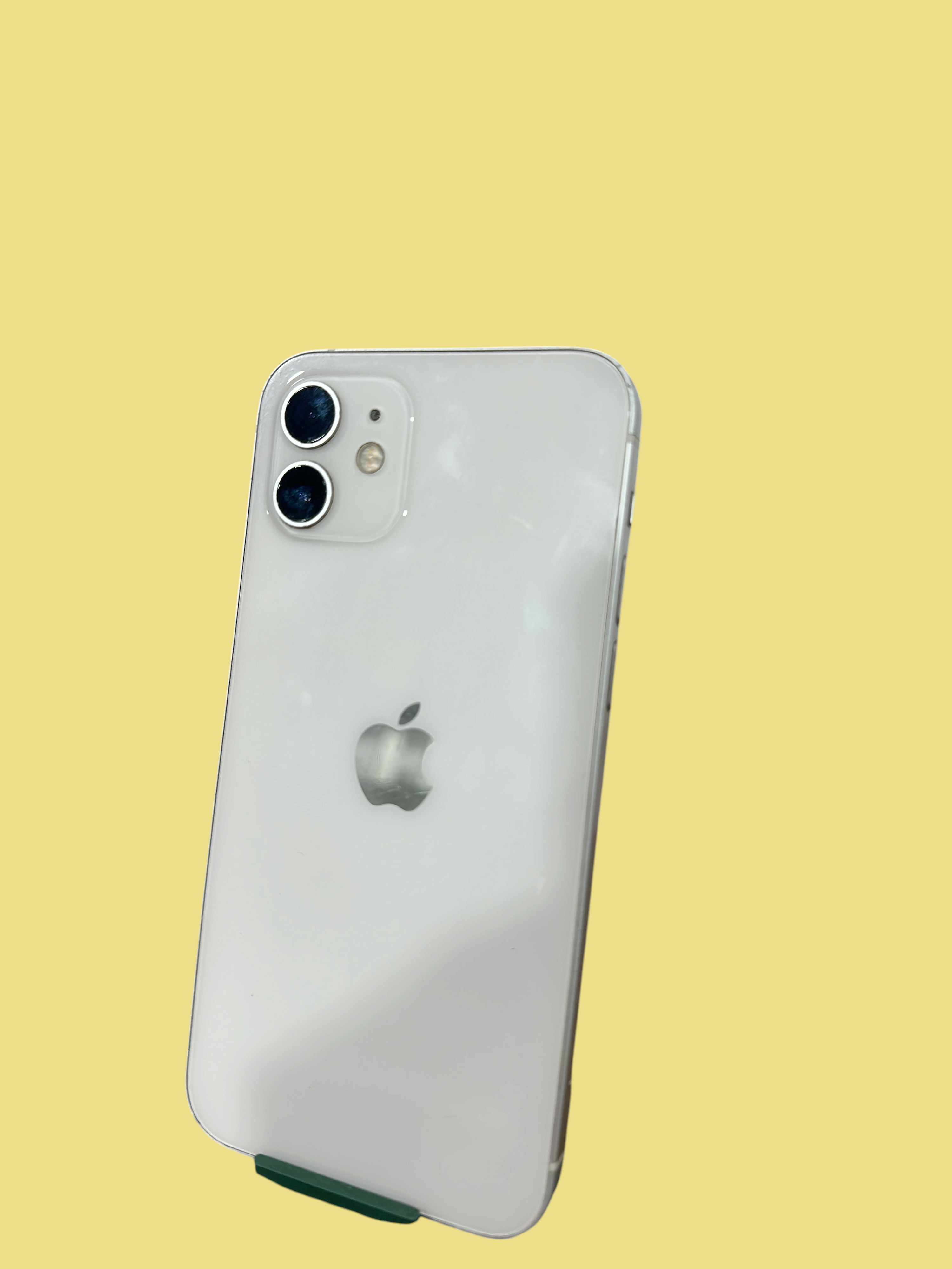Iphoneio Official white Apple iPhone 12 smartphone showing the dual-camera system and sleek glass back design