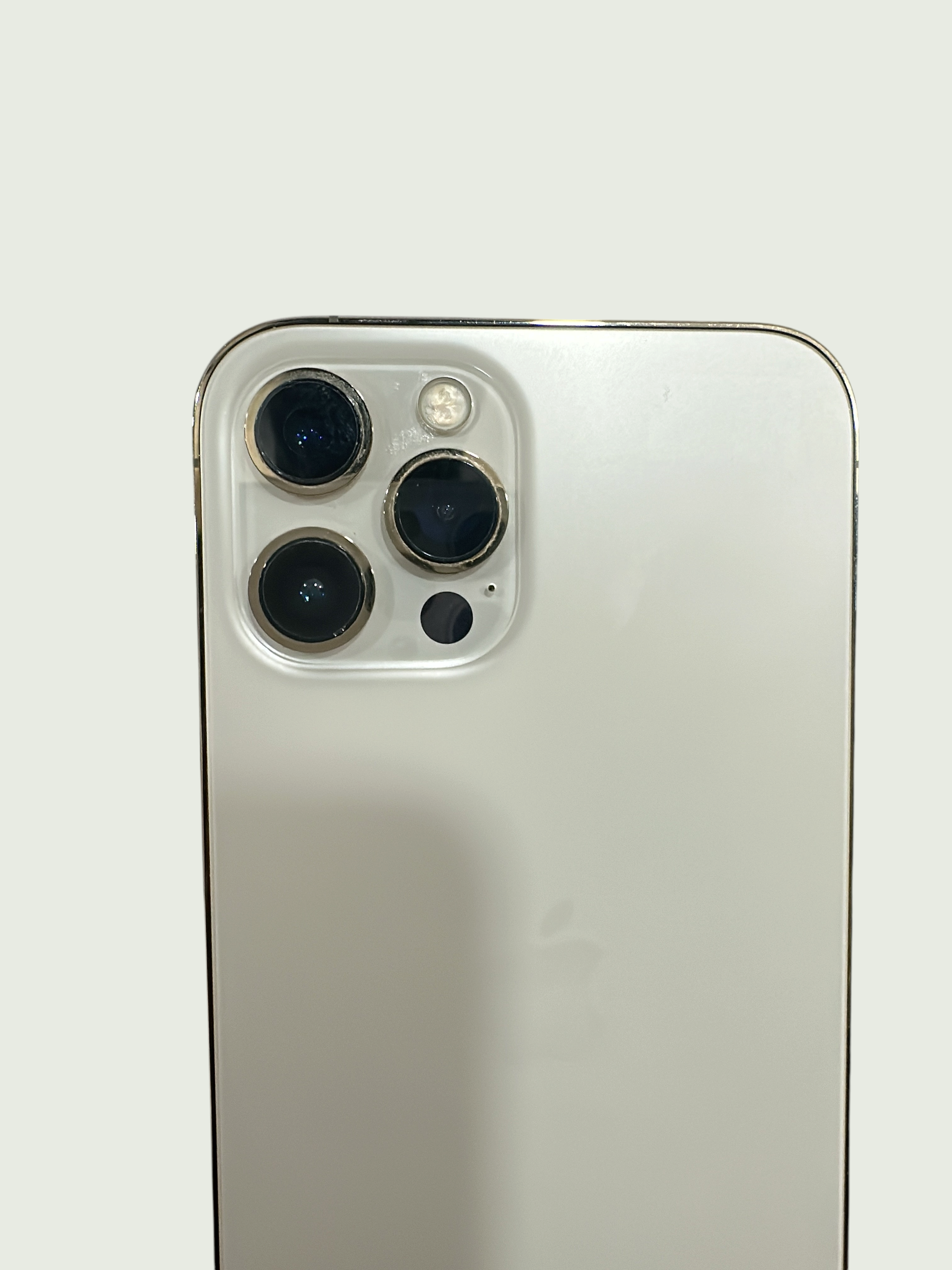 Iphoneio Official premium smartphone in white with a professional-grade triple-lens camera system and metallic frame.